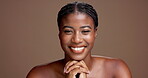 Glow, beauty and smile with face of black woman in studio for skincare, self care and hygiene. Happy, dermatology and shine with female model on brown background for mockup space and grooming