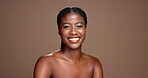 Shine, skincare and smile with face of black woman in studio for dermatology, grooming and self care. Glow, happiness and beauty with person on brown background for collagen, hydration and space