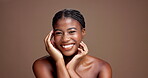 Beauty, skincare and hands with face of black woman in studio for dermatology, grooming and self care. Glow, happiness and shine with person on brown background for collagen, hydration and space
