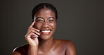 Beauty, smile and hands with face of black woman in studio for glow, dermatology and self care. Mockup space, hydration and aesthetic with female model on dark background for shine and skincare