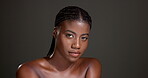 Face, confident and woman with healthy skin, studio or bodycare with cosmetics, glow or dermatology. Gray background, black person and pride for shine, soft and self care with treatment and wellness