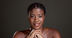 Face, healthy skin and woman with glow, studio or bodycare with cosmetics, confident or dermatology. Gray background, black person and pride for shine, soft and self care with treatment and wellness