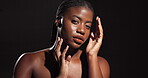 Beauty, face and girl with skincare in studio with natural glow, collagen hydration or dermatology. Spotlight, confidence and african person with results for cosmetics treatment on black background