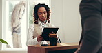 Front desk, tablet and hotel receptionist with man for accommodation, booking help and business trip. Conversation, tech and concierge with guest for hospitality, service or corporate travel check in