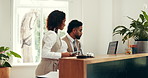 Hotel, computer or teamwork with tablet at front desk to compare booking info, availability or dates. Concierge service, people or screen with discussion for reservation management or upgrade request