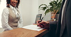Hands, person and signature at hotel reception for registration, check in and hospitality service. Pen, paper and sign with client at motel for reservation confirmation, travel or accommodation form