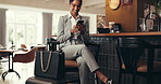 Woman, lounge and smile with phone for travel, coffee and message at cafe reception on business trip. Hospitality, accommodation and businessman in lobby with smartphone, luggage and conversation