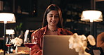 Laptop, remote work and smile of woman in restaurant at night for online planning or research. Computer, typing and wine with happy freelance employee at fine dining eatery for small business startup
