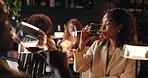 Woman, night and drinking wine in restaurant with date for romantic dinner, anniversary or occasion. Female person, man or tasting alcohol in late evening with meal for fine dining or rendezvous