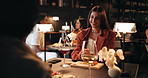 Woman, friends and night with wine in restaurant for conversation, dinner or occasion. Female people, chatting or talking in late evening with alcohol, drink or food for fine dining or discussion