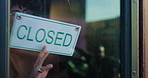 Front door, close and sign with man in cafe for small business, announcement and barista. Hospitality, restaurant manager and storefront with person in coffee shop as waiter for end of service