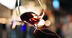 Hands, person and swirl wine in glass for taste testing, quality control and sensory ritual. Customer, inspection and red alcohol for aroma, balance flavour and evaluation process to prepare palate