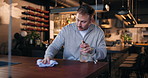 Restaurant, waiter and cleaning table with spray for hygiene maintenance, workflow or dust removal. Small business, man and cloth to wipe counter for wine bar compliance, safety policy and bacteria