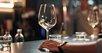 Hands, person and swirl alcohol in glass for taste testing, quality control and sensory ritual. Customer, inspection and wine expert of aroma, balance flavour and evaluation process to prepare palate