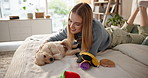 Girl, puppy and happy on bed, stroke and care with love, bonding and loyalty with pet animal at apartment. Woman, dog mom and relax with smile, touch and golden retriever fur in bedroom at house