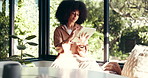 Happy, relax and black woman on tablet in home for online website, social networking and internet. House, living room and African person on digital tech for reading news, ebook and watching videos