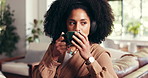 Headphones, coffee and woman on sofa in house with calm, relax or peaceful weekend with music. Audio tech, cappuccino and female person listening to morning playlist in living room at apartment.