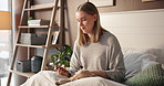 Texting, phone and woman with pet in bedroom, relax and chilling with puppy in home, online and web. Calm, person and resting with dog on bed, browsing and bonding with canine in house or mobile app