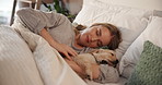 Woman, sleeping and stroke puppy in bed for rest with peace, tired and stress relief with pet for comfort. Asleep, dream and break with person in bed with dog, relax or nap with cuddling at house