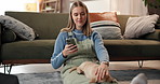 Girl, phone and puppy on floor in home for texting, relax and stroke pet with love in living room. Woman, smartphone and smile in lounge, golden retriever dog and social media app on carpet in house