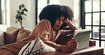 Woman, tired and bored on sofa with tablet, yawning and waiting for response on social media. African person, exhausted and tech in home with slow connection, contact and fatigue in living room