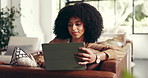 Happy, relax and black woman on tablet on sofa for online website, social networking and internet. Home, living room and African person on digital tech for reading news, ebook and watching videos