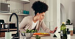 Tablet, cooking and reading with woman in kitchen for healthy food, digital recipe and vegetables. Nutrition blog, vegan diet and meal prep with person and online in home for wellness and lunch