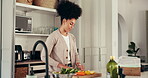 Cutting, cooking and vegetables with woman in kitchen for healthy food, ingredients and pepper. Nutrition, vegan diet and meal prep with person and wood board in home for recipe, wellness and lunch