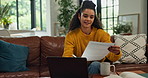 Documents, laptop and smile of woman on sofa in living room of home for budget or finance review. Computer, investment contract and paper with happy person in apartment for financial or tax report