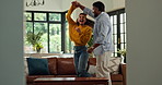Laugh, dancing and couple in home with music, fun or bonding together in living room with energy. Smile, love and man with woman for moving to playlist, album or radio for entertainment in apartment.