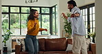 Happy, dancing and couple in house with music, fun or bonding together in living room with energy. Smile, love and man with woman for moving to playlist, album or radio for entertainment in apartment