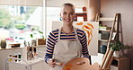 Happy woman, face and painter with palette in workshop, creativity and laugh with career or hobby. Pride, talent with confidence and artist with painting tools, smile and portrait in art studio