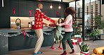 Christmas, dance and parents holding hands with child in home for celebration, bonding and fun. Family, December and excited mom, dad and kid with music for xmas holiday, festive season and tradition
