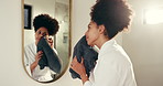 Woman, mirror and drying with towel for facial treatment, hygiene or skincare in bathroom. Female person, face and reflection with cloth or wipe in robe for dermatology, health or wellness in home