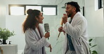 Dancing, couple and karaoke in bathroom, morning routine and sing with brush in home, silly and fun. Happy, man and bonding with woman in house, romance and people with rhythm, smile or getting ready