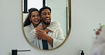 Happy couple, hug or laughing with mirror in bathroom for grooming, skincare or beauty together in home. Man, woman and embrace with smile or reflection in robe for hygiene or spa treatment in house