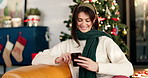 Smile, woman and phone on Christmas at house for social media, browsing internet and gift search. Female person, laugh and mobile for funny message, online shopping and reading meme of festive season