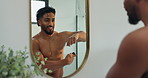 Happy man, deodorant and spraying with mirror for hygiene, odor or masculine fragrance in bathroom. Shirtless, male person or armpit with smile or perfume for scent, aroma or fresh smell in home