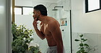 Shirtless, man and grooming in bathroom, mirror and fresh shave in home, morning routine and muscle. Happy, person and checking beard in house, getting ready and smile for abs, wellness or self care