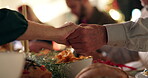 Holding hands, people and Christmas dinner with prayer for worship, gratitude or thanks to God for the food. Tradition, community or family with faith, saying grace or praise at holiday celebration