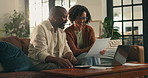 Happy, black couple and documents with laptop in home for finance, expenses or budget planning. Man, woman and paperwork with computer on sofa for financial discussion, bills or invoice in house