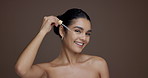 Woman, dropper and face for skincare in studio, liquid or hyaluronic acid for beauty by background. Girl, oil and smile for dermatology, cosmetics or space with results, benefits or serum in Peru