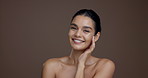 Touch face, skincare and woman with beauty, natural aesthetic and glow on studio background space. Portrait, smile and model with facial cosmetics for collagen treatment, results or skin wellness