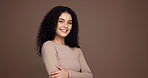 Face, hair care and happy woman in studio for glow, texture or natural beauty on brown background. Portrait, curly hairstyle and confident model with cosmetics for growth, hairdresser or mockup space