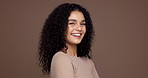 Face, hair care and happy woman in studio for beauty, texture and volume on brown background. Portrait, curly hairstyle and confident model with cosmetics for growth, hairdresser and mockup space