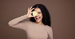Happy woman, face and vitamin c with lemon in studio for citrus acid or detox on a brown background. Portrait, female person or model with smile or natural organic fruit for health or diet on space