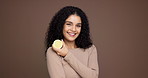 Happy woman, face and diet with lemon in studio for citrus acid or detox on a brown background. Portrait, female person or model with smile or natural organic fruit for vitamin c or health on space