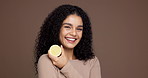 Happy woman, face and lemon with fruit in studio for citrus acid or detox on a brown background. Portrait, female person or model with smile for natural organic diet, vitamin c or health on space