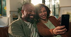 Mature African couple, selfie and smile on sofa, hug or care in living room with photography in home. Woman, man and happy on couch for memory, profile picture or bonding on social network in house