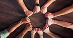 Circle, fist bump and business people in office with collaboration, solidarity and synergy. Top view, teamwork and group of corporate employees with hands together for partnership, unity and goals.